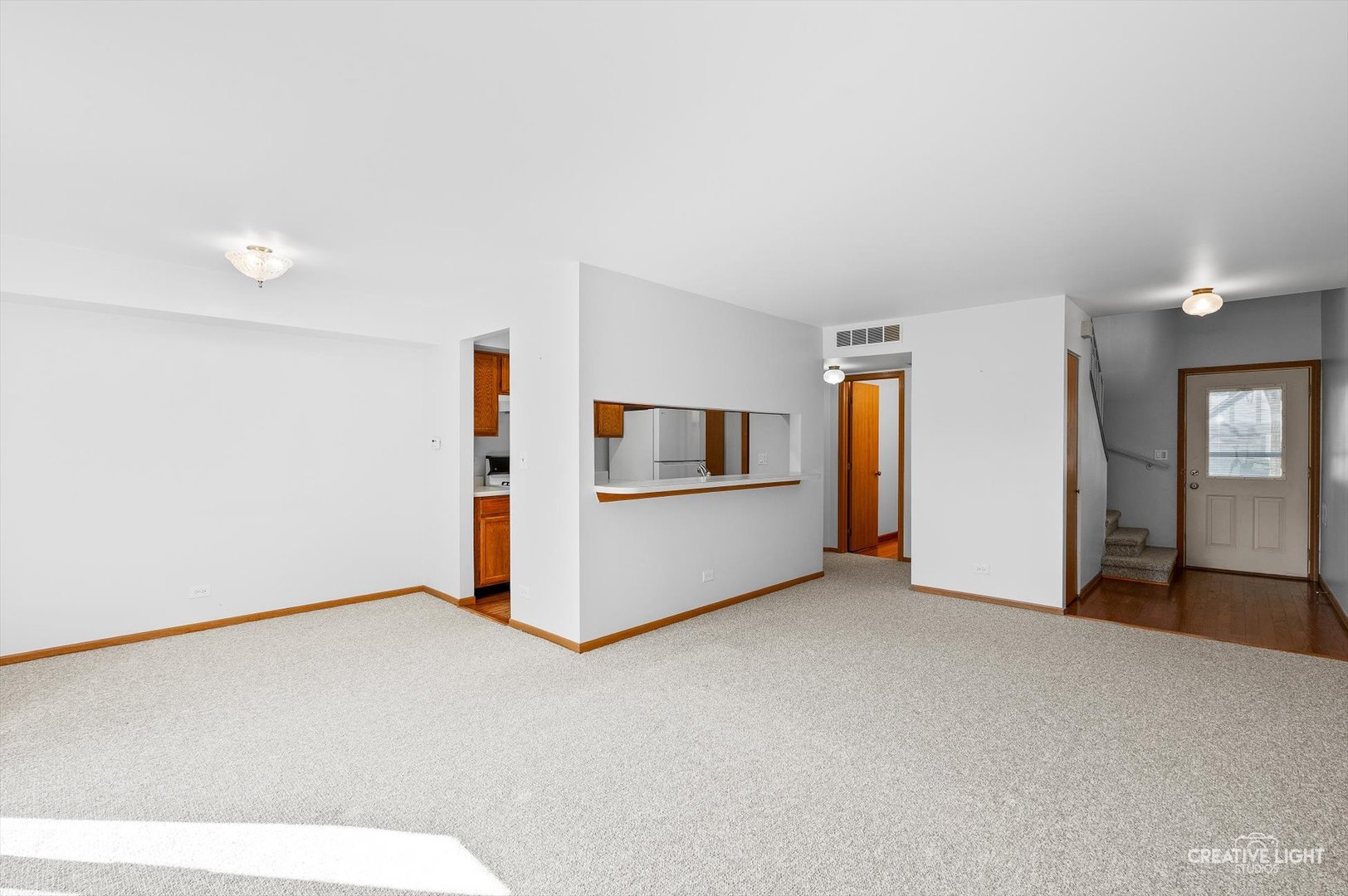 7419 Canterbury Place Downers Grove, IL 60516 - Photo 6 of 17 a view of an empty room with kitchen and a window