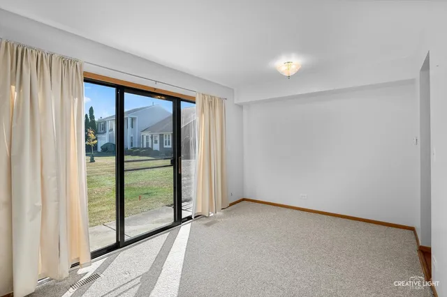 a view of an empty room with glass door