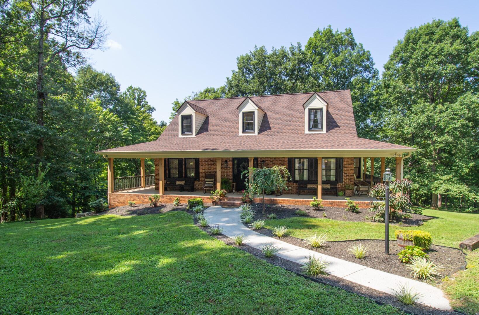 2420 Roaring Run Road Goode, VA 24556 - Photo 1 of 53 a front view of a house with a yard table and chairs