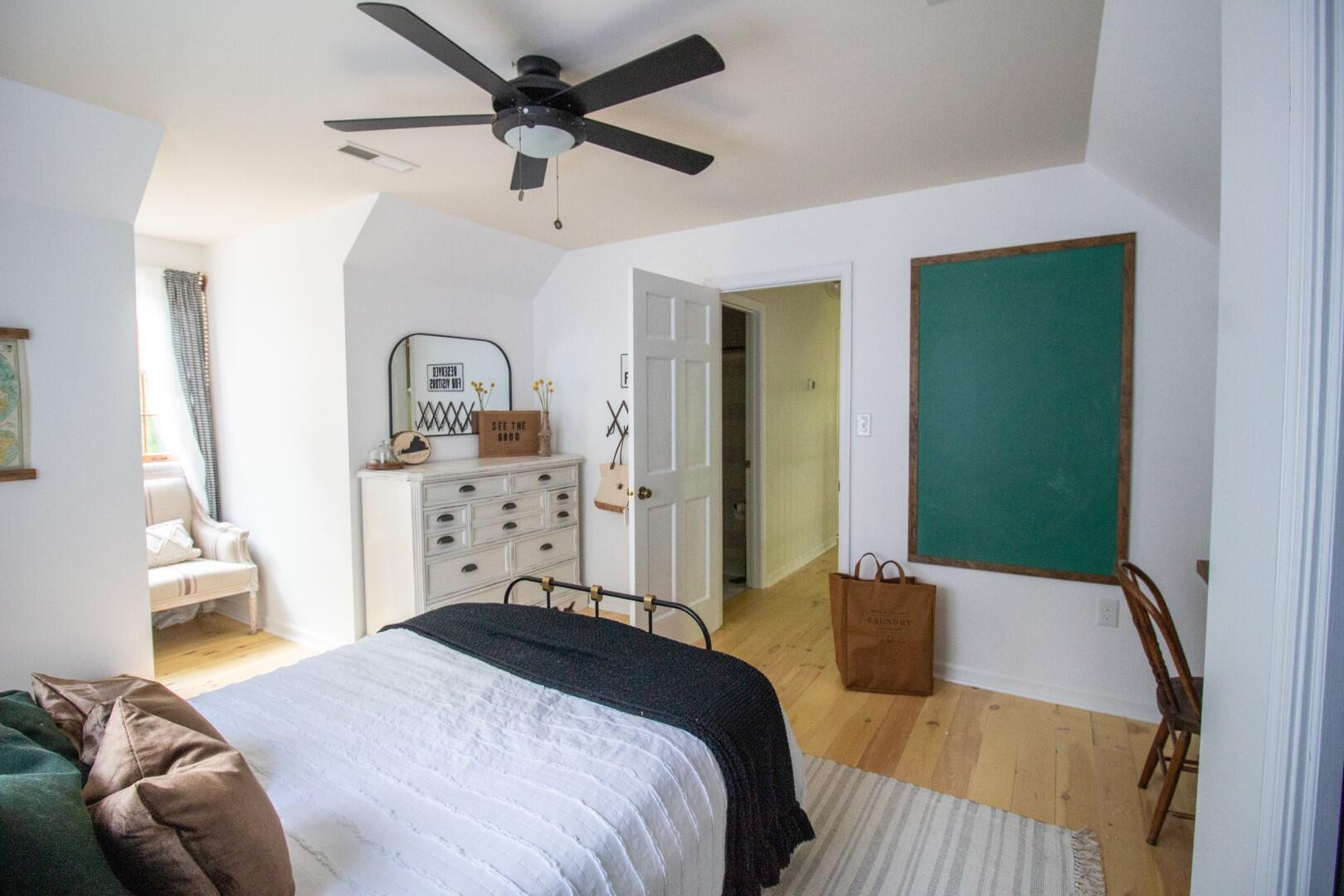 2420 Roaring Run Road Goode, VA 24556 - Photo 28 of 53 a bedroom with a bed and a chandelier