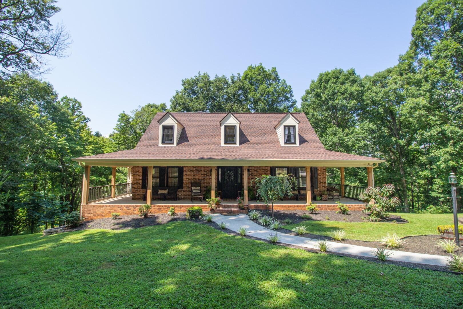 2420 Roaring Run Road Goode, VA 24556 - Photo 32 of 53 a front view of a house with a yard table and chairs
