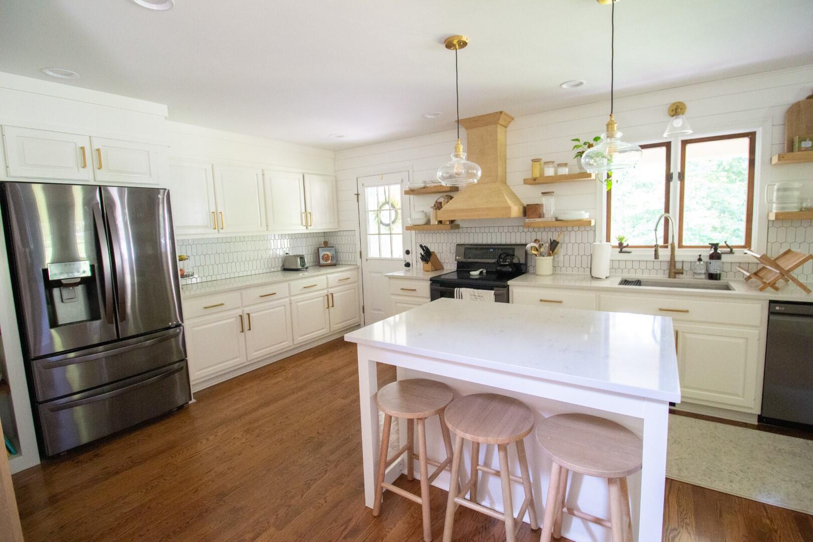2420 Roaring Run Road Goode, VA 24556 - Photo 46 of 53 a kitchen with kitchen island a stove a sink a center island and stainless steel appliances