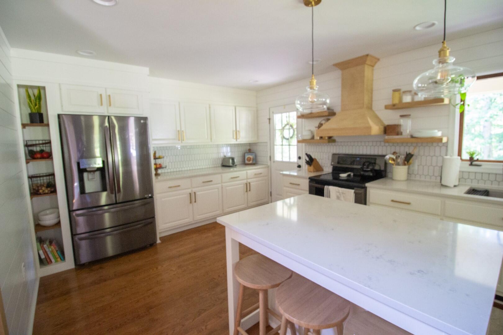 2420 Roaring Run Road Goode, VA 24556 - Photo 47 of 53 a kitchen with refrigerator cabinets and wooden floor