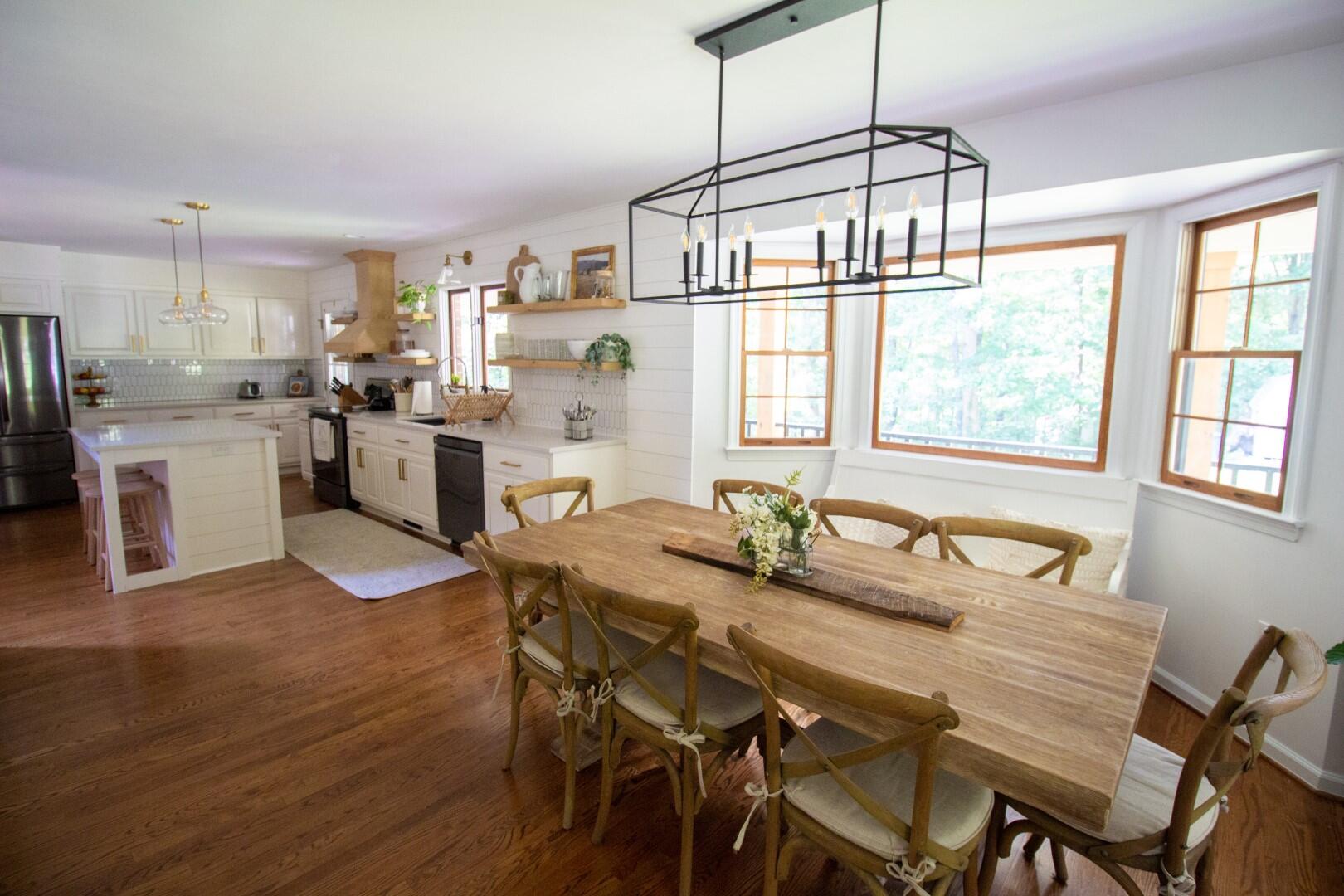 2420 Roaring Run Road Goode, VA 24556 - Photo 50 of 53 a dining room with furniture a chandelier and wooden floor