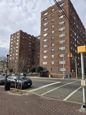 a view of a building and car parked on the road
