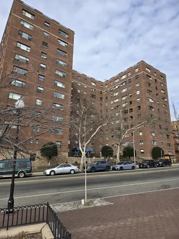 a view of a building and a cars park