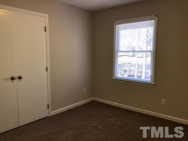 1121 Toppe Ridge Court Raleigh, NC 27615 - Photo 8 of 9 an empty room with a window