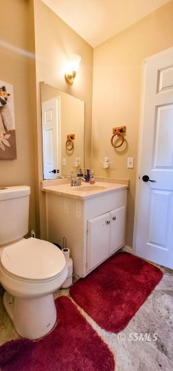 548 South Sanders Street Ridgecrest, CA 93555 - Photo 18 of 29 a bathroom with a sink toilet and mirror