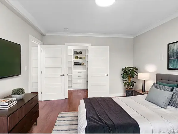 a bedroom with a bed and a flat screen tv