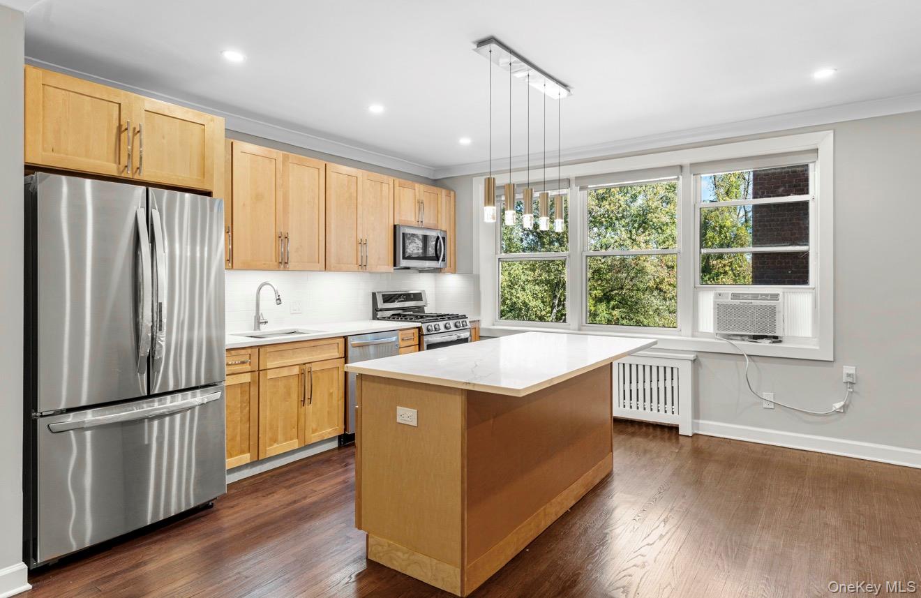 1133 Midland Avenue, Unit 3D Bronxville, NY 10708 - Photo 3 of 20 a kitchen with a refrigerator a sink and cabinets