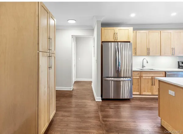 a kitchen with stainless steel appliances granite countertop a refrigerator and a stove top oven