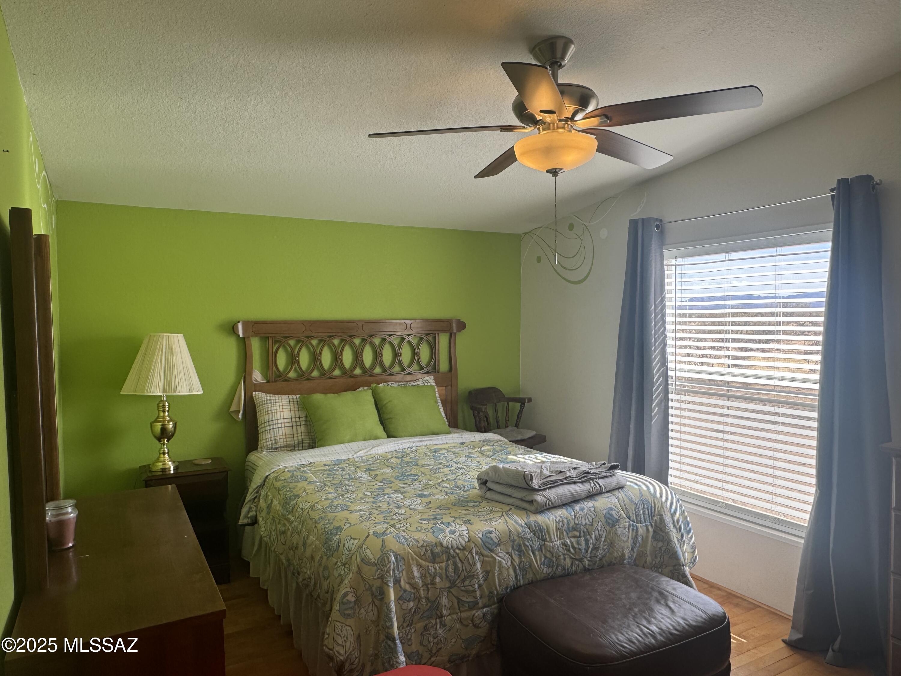 12440 South Coleman Road Tucson, AZ 85735 - Photo 32 of 45 a bed sitting in a bedroom next to a window