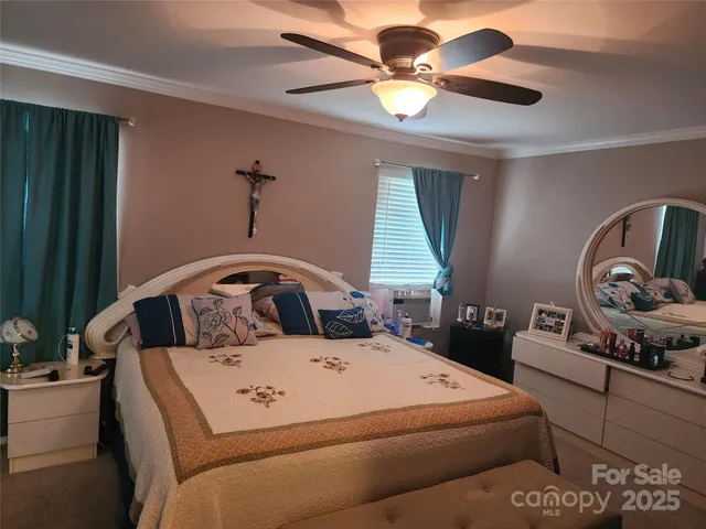 a bedroom with a bed and a chandelier