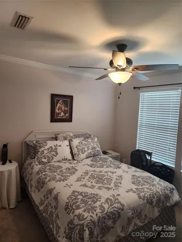 a bedroom with a bed window and a chair