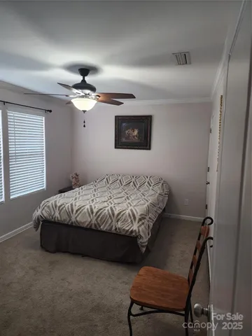 a bathroom with a toilet and a shower curtain