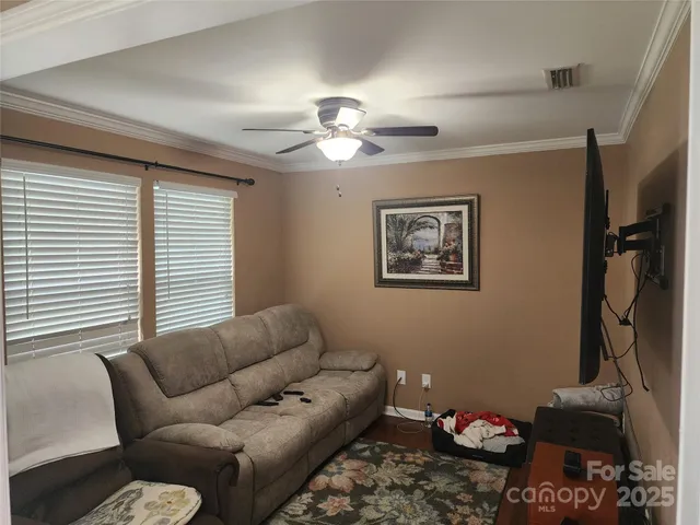 a kitchen with stainless steel appliances granite countertop a stove a refrigerator a sink a dining table and chairs