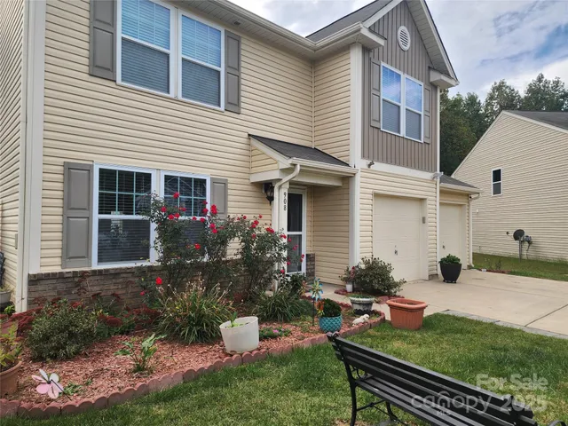 a view of a house with backyard sitting area and garden