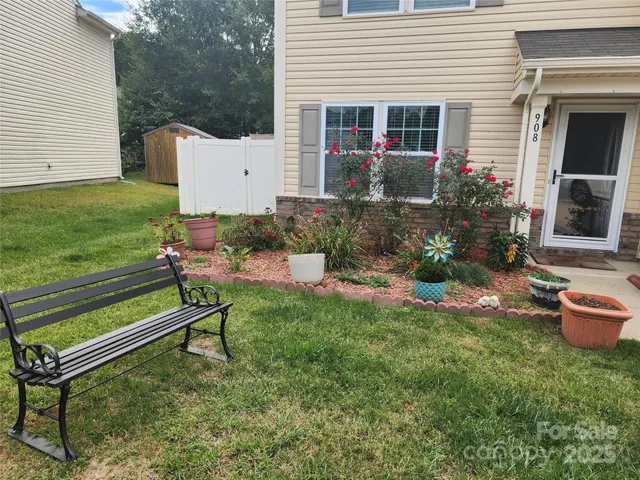 a view of a house with backyard and sitting area