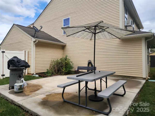 a view of a patio with table and chairs