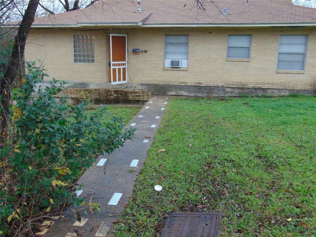 1701 East 38th Street, Unit 1611 Austin, TX 78722 - Photo 2 of 9 a front view of a house with a yard