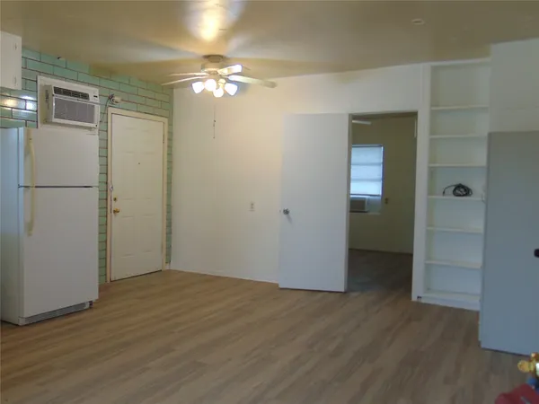 an empty room with wooden floor