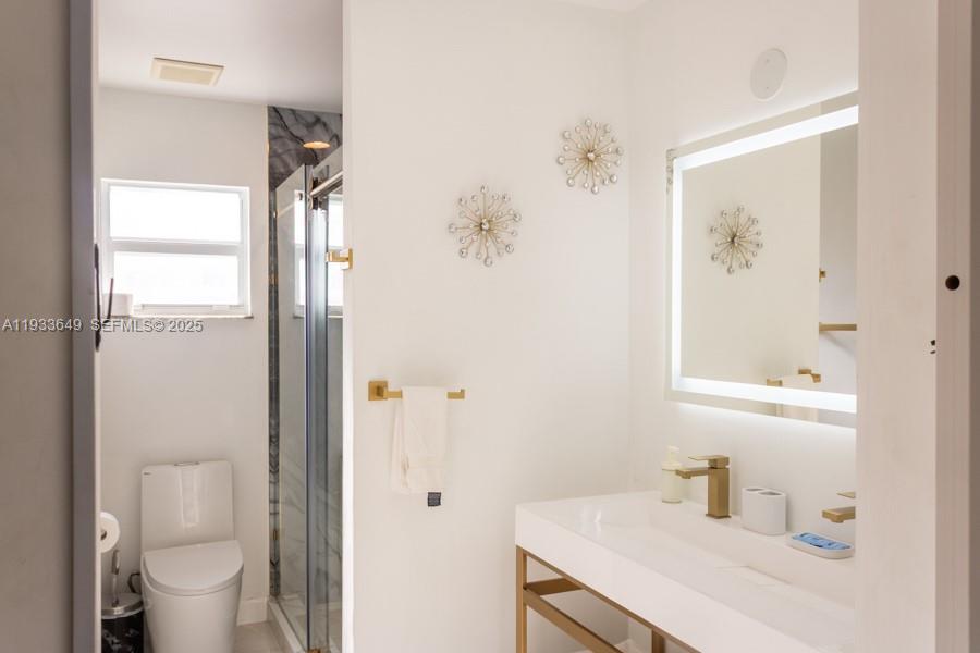 765 Northwest 77th Street Miami, FL 33150 - Photo 13 of 23 a bathroom with a sink toilet and shower