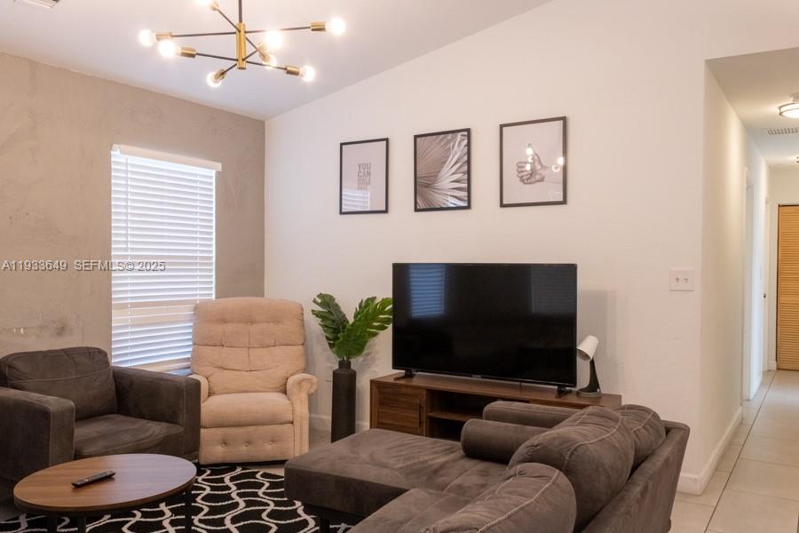 765 Northwest 77th Street Miami, FL 33150 - Photo 18 of 23 a living room with furniture and a flat screen tv