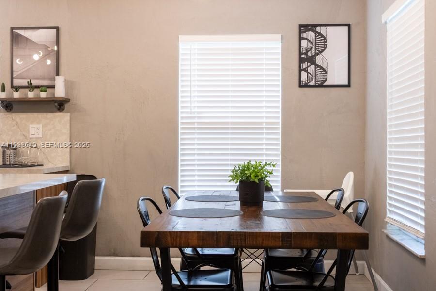 765 Northwest 77th Street Miami, FL 33150 - Photo 21 of 23 a view of a dining room with furniture and wooden floor