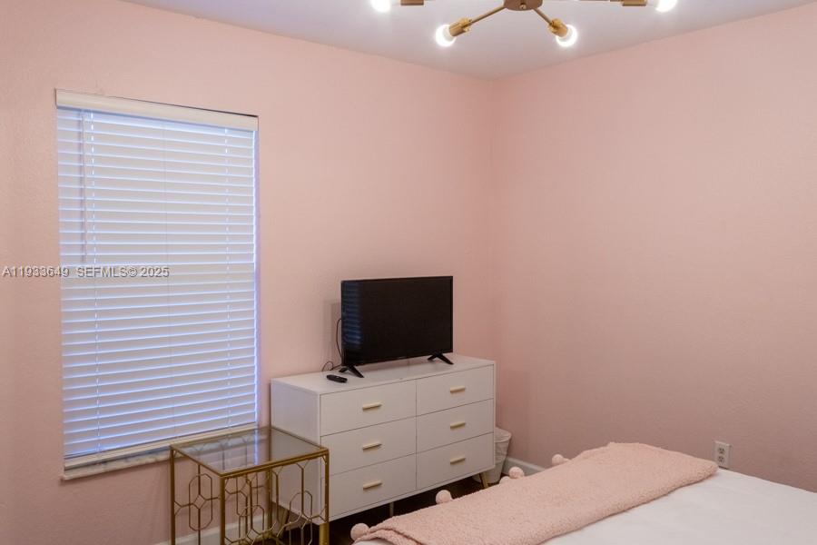 765 Northwest 77th Street Miami, FL 33150 - Photo 6 of 23 a room with furniture and flat screen tv