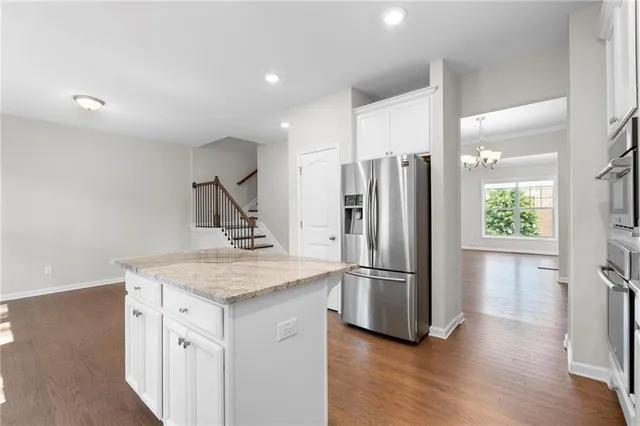 a kitchen with stainless steel appliances granite countertop a refrigerator and a sink
