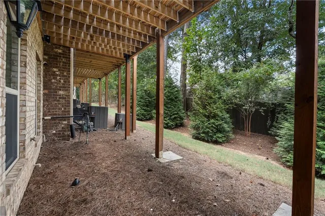a view of a patio with table and chairs and floor to ceiling window