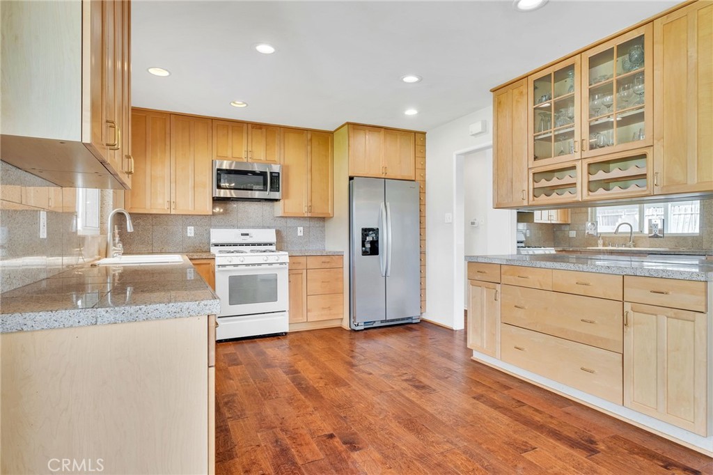 1607 Blackwall Drive Simi Valley, CA 93063 - Photo 11 of 47 a kitchen with granite countertop a refrigerator and a sink