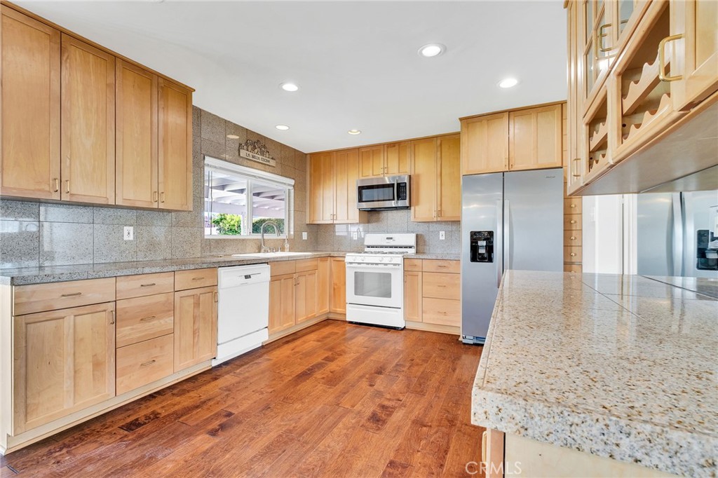 1607 Blackwall Drive Simi Valley, CA 93063 - Photo 12 of 47 a kitchen with white cabinets and stainless steel appliances