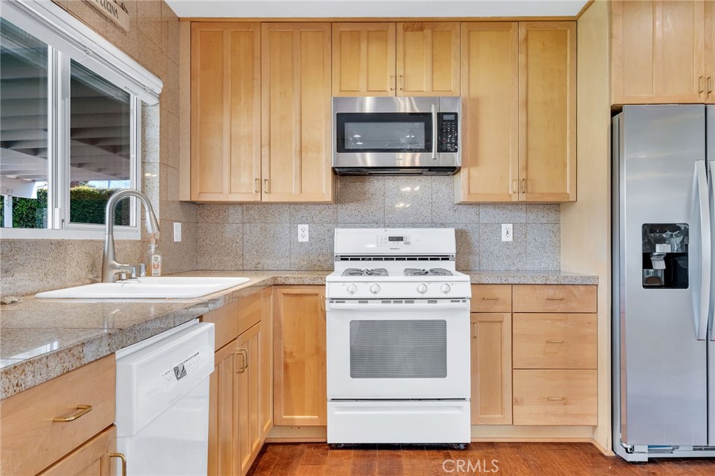 1607 Blackwall Drive Simi Valley, CA 93063 - Photo 13 of 47 a kitchen with stainless steel appliances granite countertop a sink stove and refrigerator