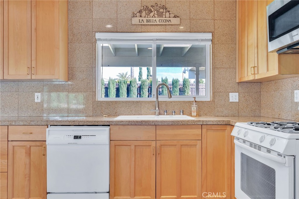 1607 Blackwall Drive Simi Valley, CA 93063 - Photo 14 of 47 a kitchen with granite countertop a sink stove and cabinets