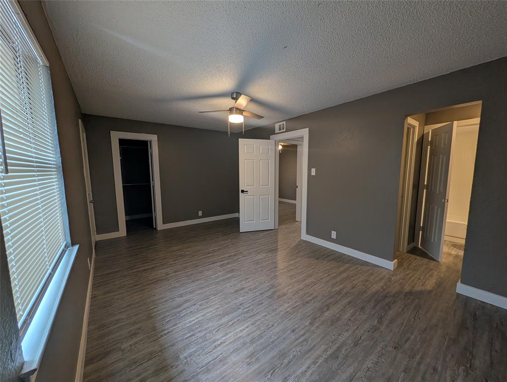 6709 Ridgecrest Court Fort Worth, TX 76133 - Photo 13 of 19 an empty room with wooden floor and windows