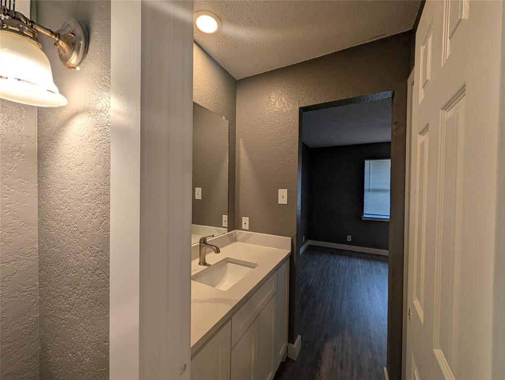6709 Ridgecrest Court Fort Worth, TX 76133 - Photo 8 of 19 a bathroom with a sink and a mirror