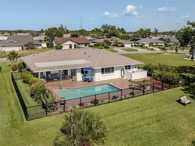an aerial view of a house with garden space and street view