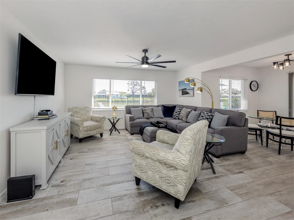 1232 Pine Needle Road Venice, FL 34285 - Photo 29 of 91 a living room with furniture and a flat screen tv