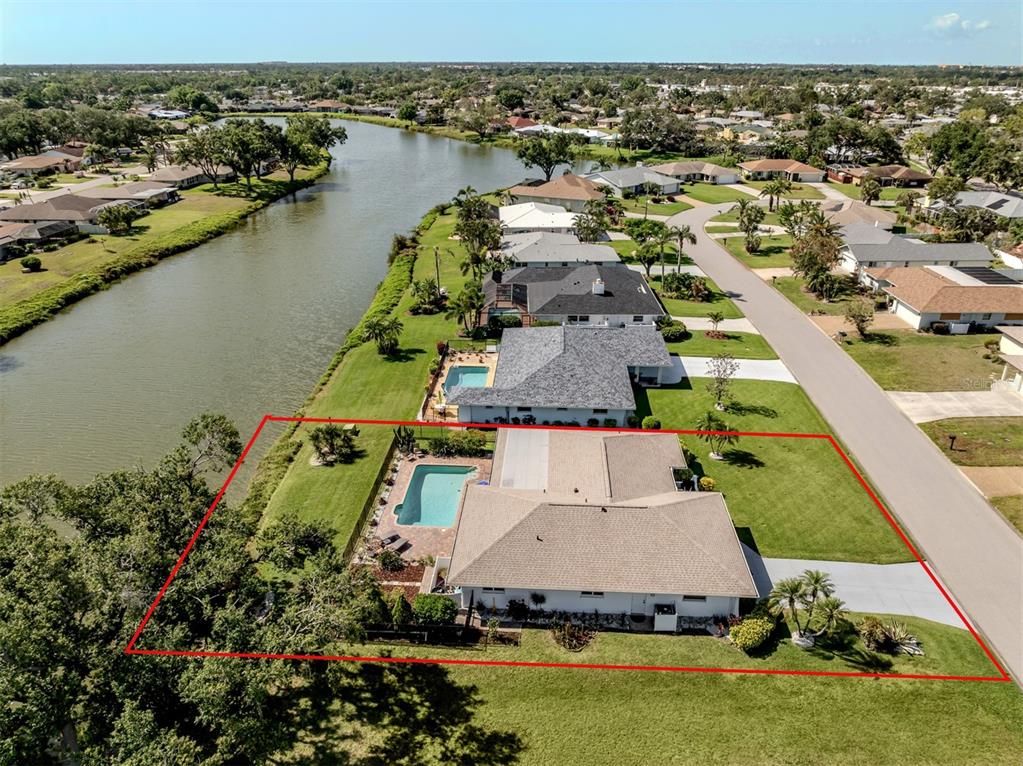1232 Pine Needle Road Venice, FL 34285 - Photo 4 of 91 an aerial view of a house with a lake view