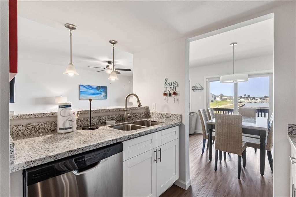 620 Fulton Beach Road, Unit 308 Rockport, TX 78382 - Photo 11 of 30 a kitchen with center island appliances and wooden floor