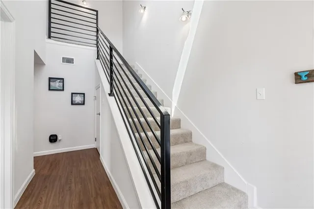 a view of entryway and hall with wooden floor