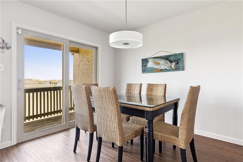 620 Fulton Beach Road, Unit 308 Rockport, TX 78382 - Photo 7 of 30 a view of a dining room with furniture and wooden floor