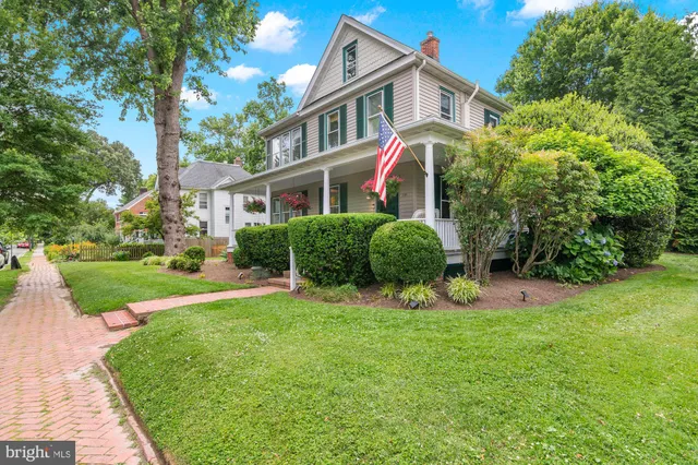 a view of a house with a yard and a garden