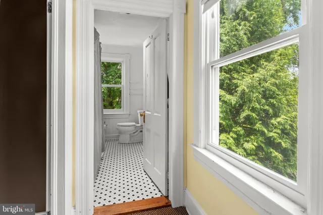 a view of a chairs and table in backyard of a house