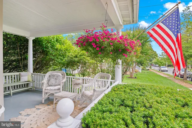 a large living room with a chandelier furniture and a potted plant