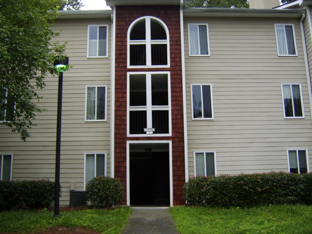 a front view of a house with yard and green space