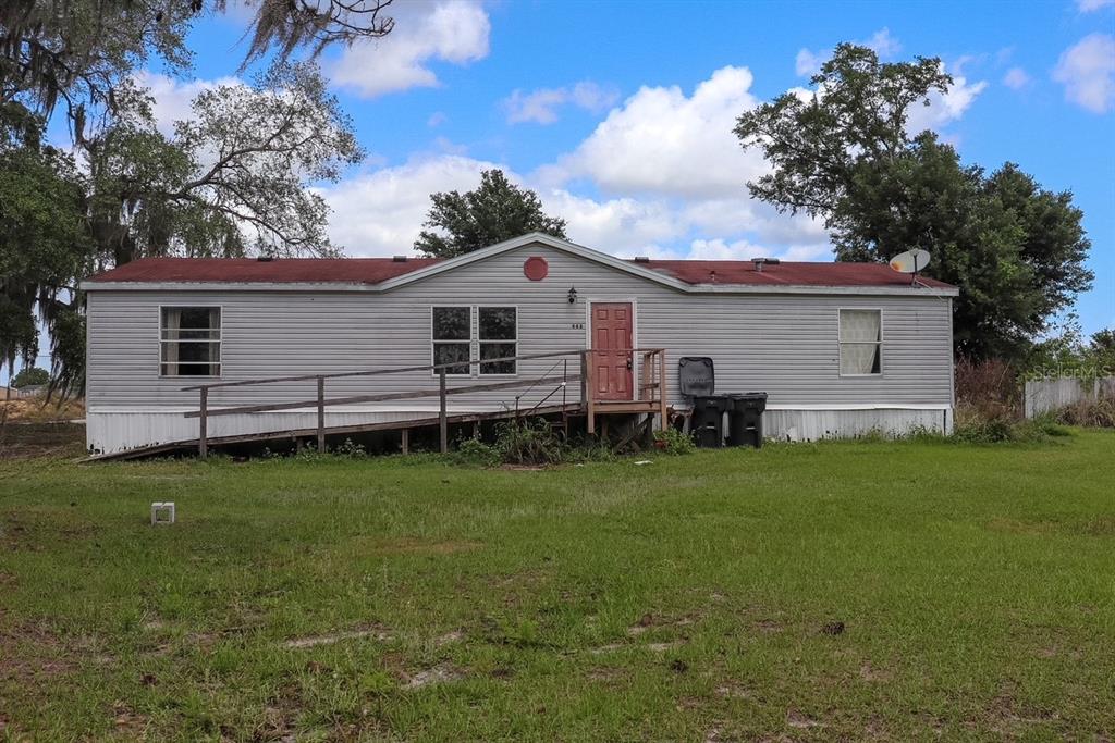 a view of a house with a backyard