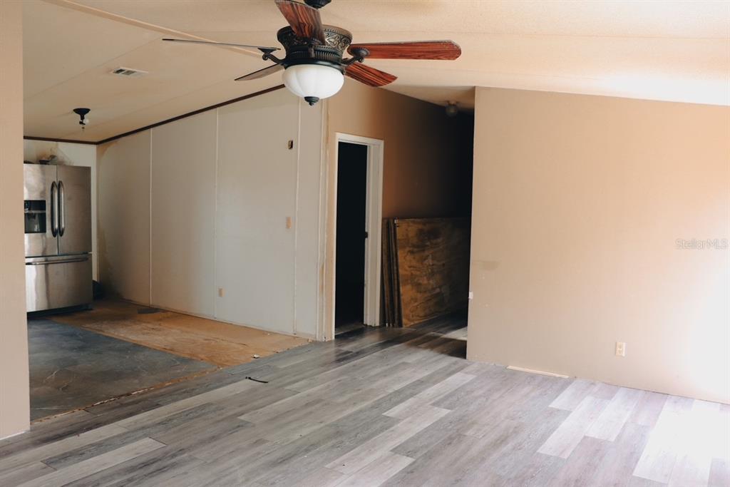 448 Fernandez Street Winter Haven, FL 33880 - Photo 12 of 27 an empty room with wooden floor closet and windows