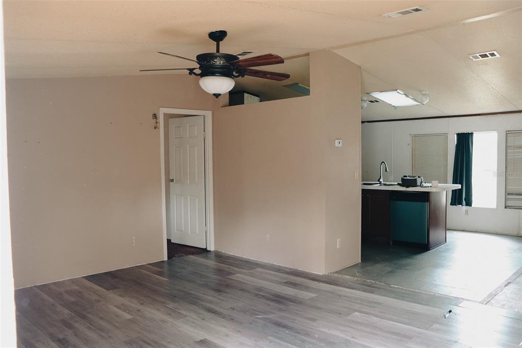 448 Fernandez Street Winter Haven, FL 33880 - Photo 3 of 27 a view of a kitchen with a sink and a refrigerator